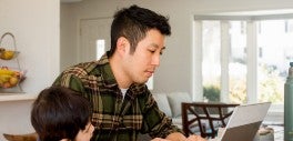 Image of man looking at laptop
